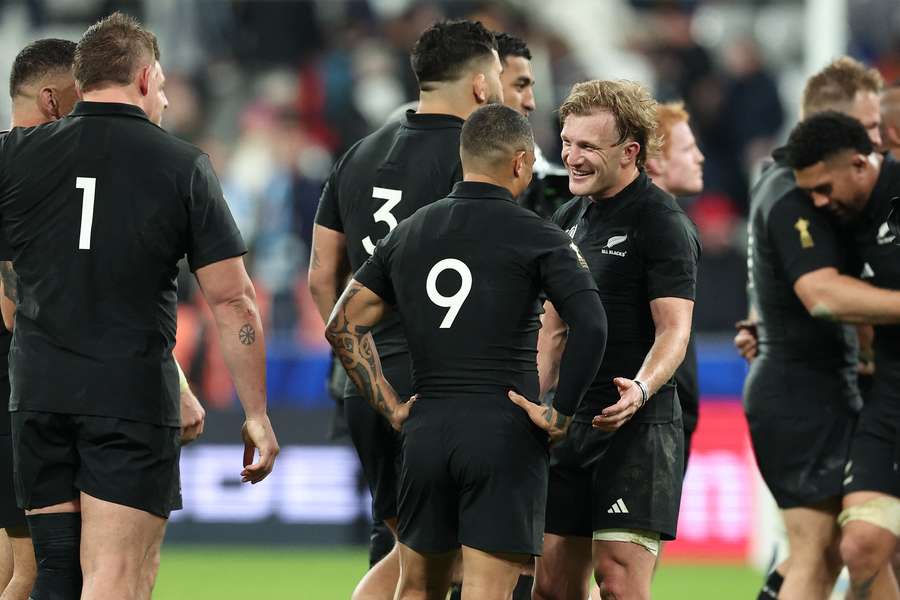 New Zealand's scrum-half Aaron Smith (#09) and New Zealand's fly-half Damian McKenzie celebrate the victory