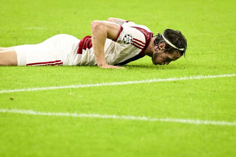 Wout Weghorst falls to the ground during the Champions League game between Ajax and Inter
