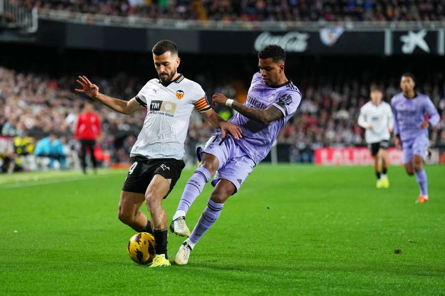 Jose Gaya (L) of Valencia and Real Madrid's Rodrygo fight for the ball