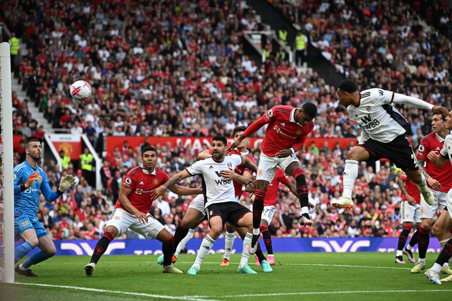 Fulham's Dutch defender Kenny Tete (R) heads home the opening goal during the English Premier League football match between Manchester United and Fulham