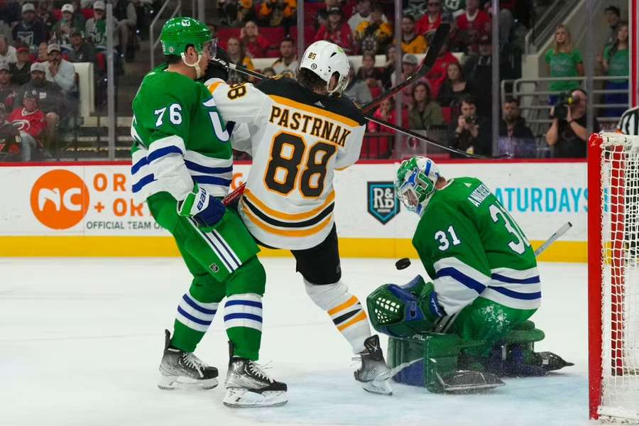 Hurricanes goaltender Andersen and defenceman Skjei stop the scoring attempt by Bruins' Pastrnak