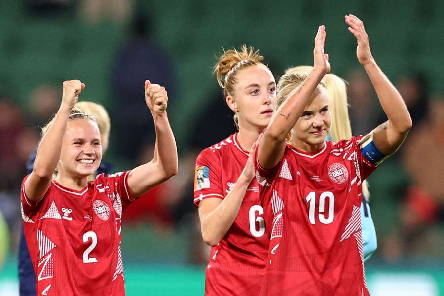 Denmark's Pernille Harder, Josefine Hasbo and Karen Holmgaard celebrate after the win over China