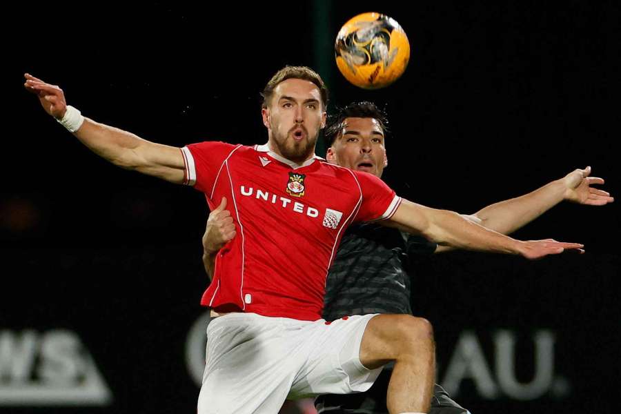 Wrexham's Sam Smith in action with Ipswich Town's Jacob Greaves