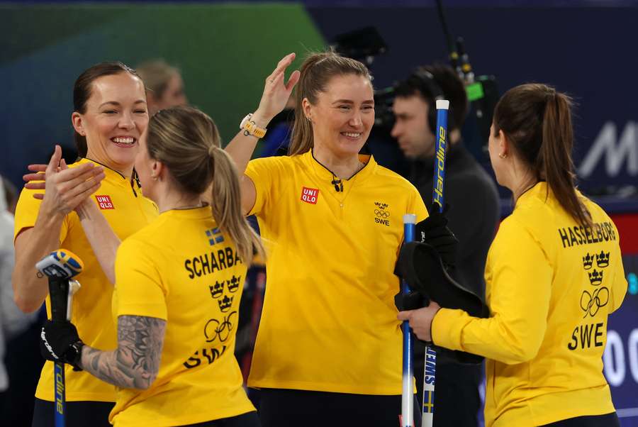 Sweden's curlers celebrate their win over Japan