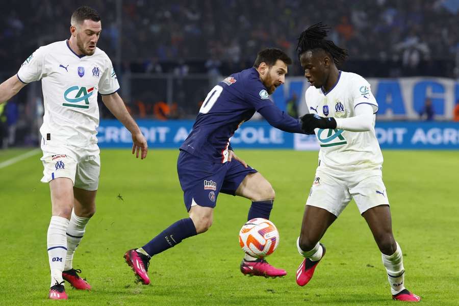 Paris St Germain's Lionel Messi in action with Olympique de Marseille's Jordan Veretout and Issa Kabore