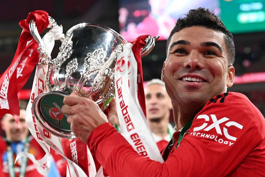 Manchester United's Brazilian midfielder Casemiro celebrates with the trophy