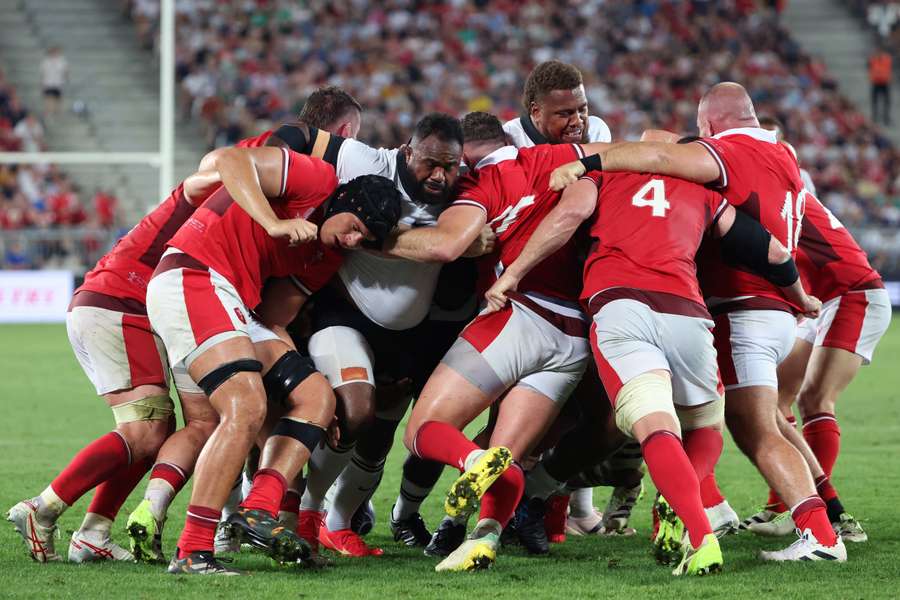 The Wales and Fiji players clash during their match