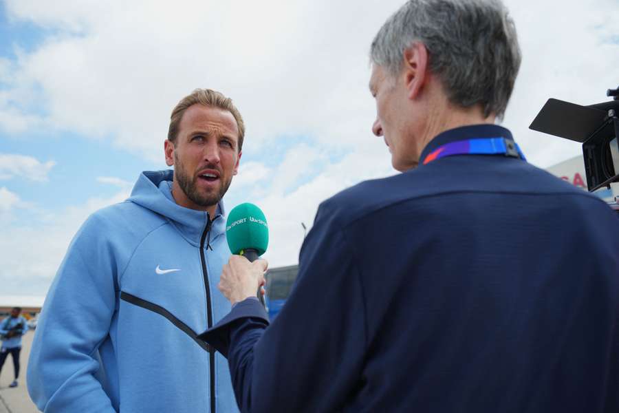 Harry Kane is interviewed after the England team arrive at the airport in Kansas City Harry Kane is interviewed after the England team arrive at the airport in Kansas City