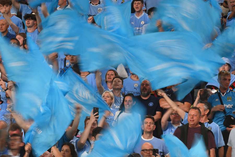 Man City supporters wave flags prior to kick-off