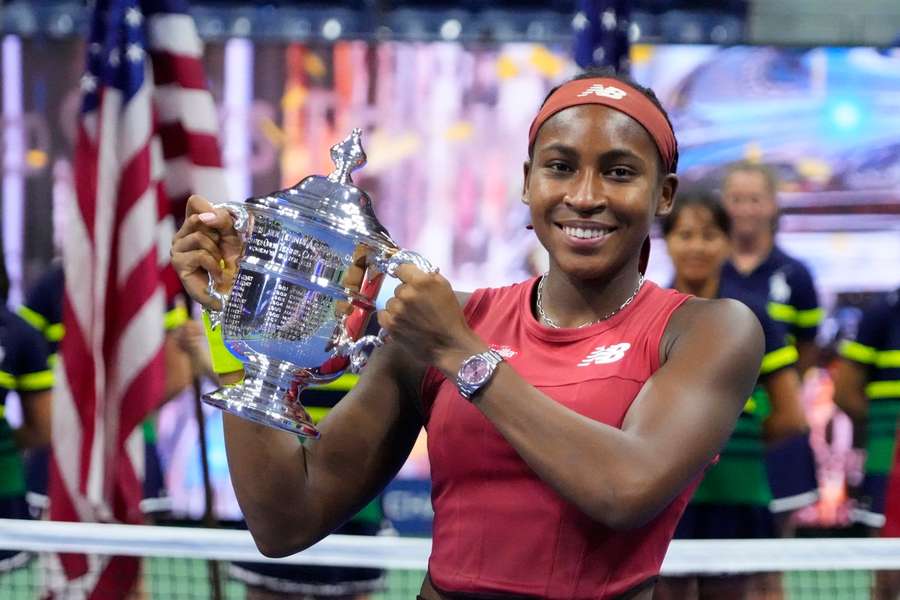 Coco Gauff celebrates with the US Open trophy