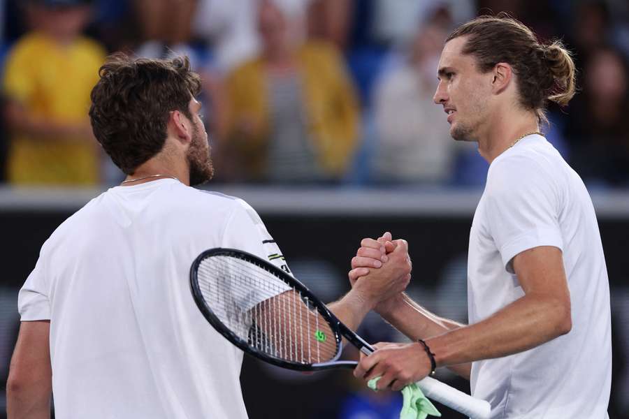 Germany's Alexander Zverev (R) shakes hands with Britain's Cameron Norrie after their men's singles match