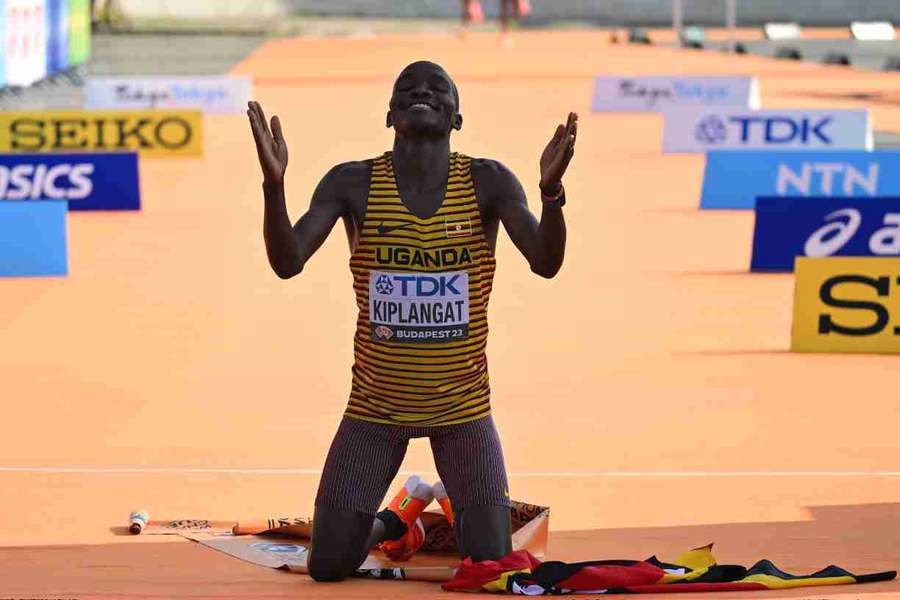 Victor Kiplangat celebrates after crossing the finish line to win the men's marathon