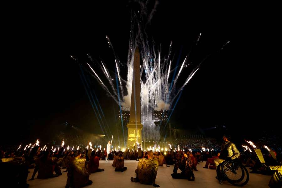 The torch relay as the Obelisk of Luxor on the Place de la Concorde is seen during the opening ceremony