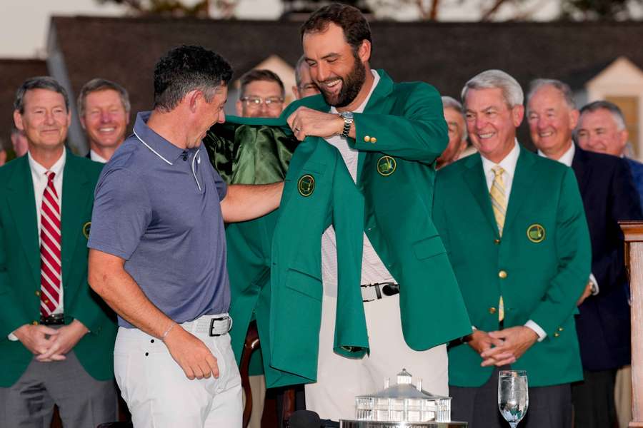 Scottie Scheffler hands the iconic green jacket to Rory McIlroy