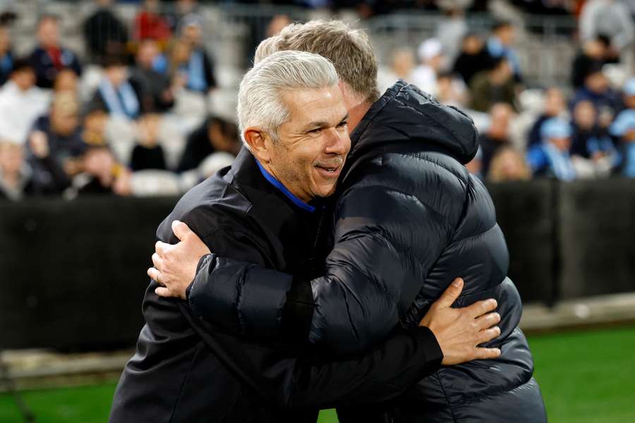 Steve Corica embraces Sydney FC head coach Ufuk Talay after Auckland's Australia Cup quarter-final win. 