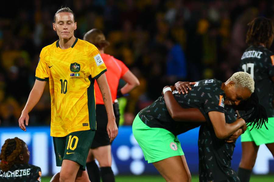 Nigeria's defender #05 Onome Ebi (C) and Nigeria's defender #03 Osinachi Ohale (R) celebrate their team's victory as Australia's midfielder #10 Emily Van Egmond reacts Nigeria's defender #05 Onome Ebi (C) and Nigeria's defender #03 Osinachi Ohale (R) celebrate their team's victory as Australia's midfielder #10 Emily Van Egmond reacts