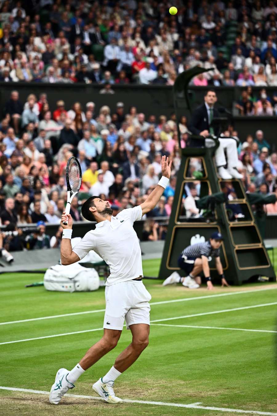 Novak Djokovic serves the ball to Jannik Sinner
