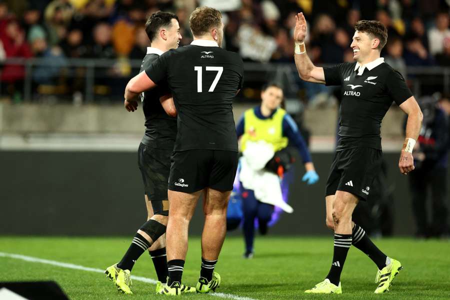 All Blacks winger Will Jordan celebrates a try with his teammates.