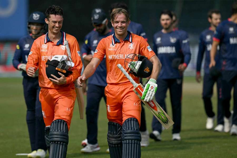 Netherlands' captain Scott Edwards and Bas de Leede walk back to the pavilion as they celebrate their team's win against Namibia 