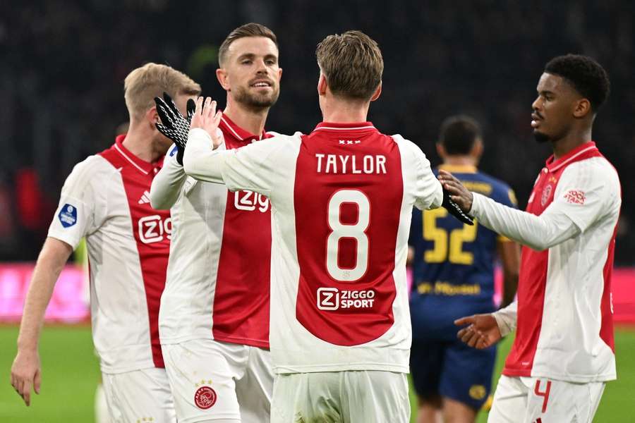 Kenneth Taylor (#8) celebrates his goal with team-mates Jordan Henderson and Jorrel Hato (R)