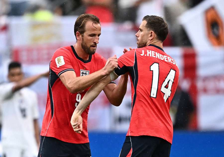 Harry Kane gives the captain's armband to Jordan Henderson after being substituted