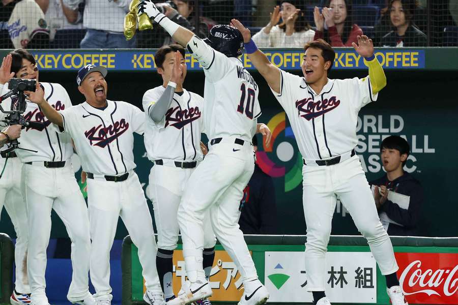 South Korea's bench celebrates Shay Whitcomb's first home run of the day
