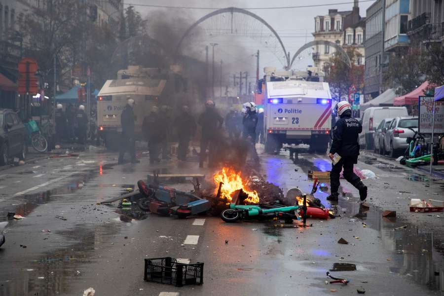 Riot police clear the street during clashes with supporters after Belgium's World Cup match with Morocco.