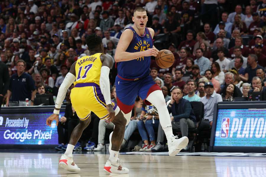 Jokic (R) powers down the court