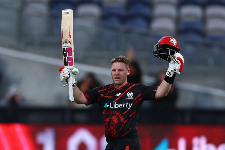 Tim Seifert raises the bat as the first BBL centurion at GMHBA Stadium.