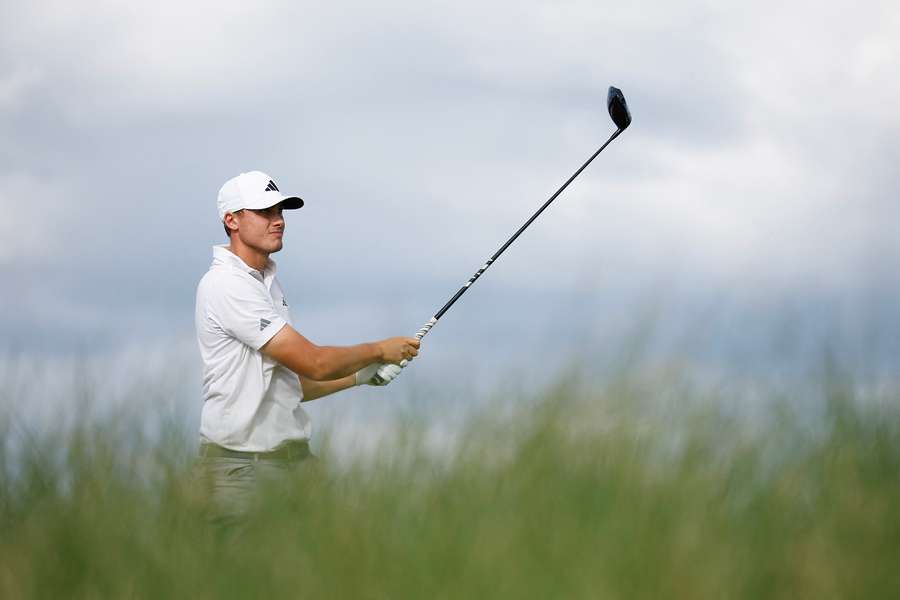 Ludvig Aberg is pictured hitting a tee shot on the 15th hole