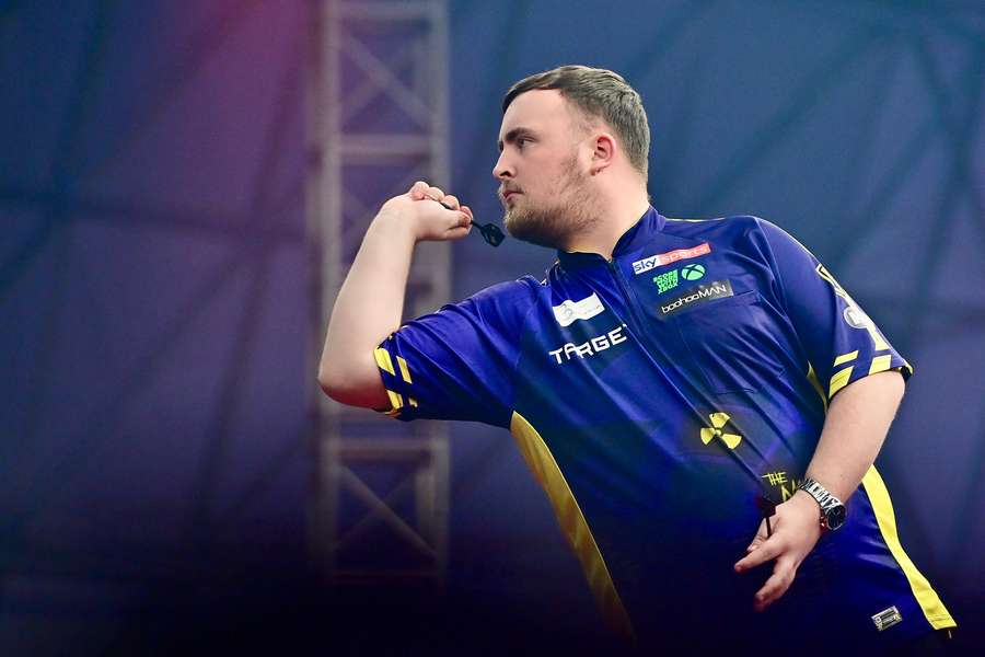 Luke Littler throws against Lourence Illagan at the Bahrain Darts Masters
