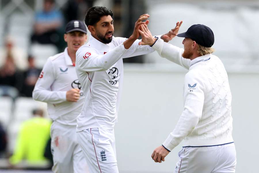 England's Shoaib Bashir (L) celebrates with England's captain Ben Stokes (R) 