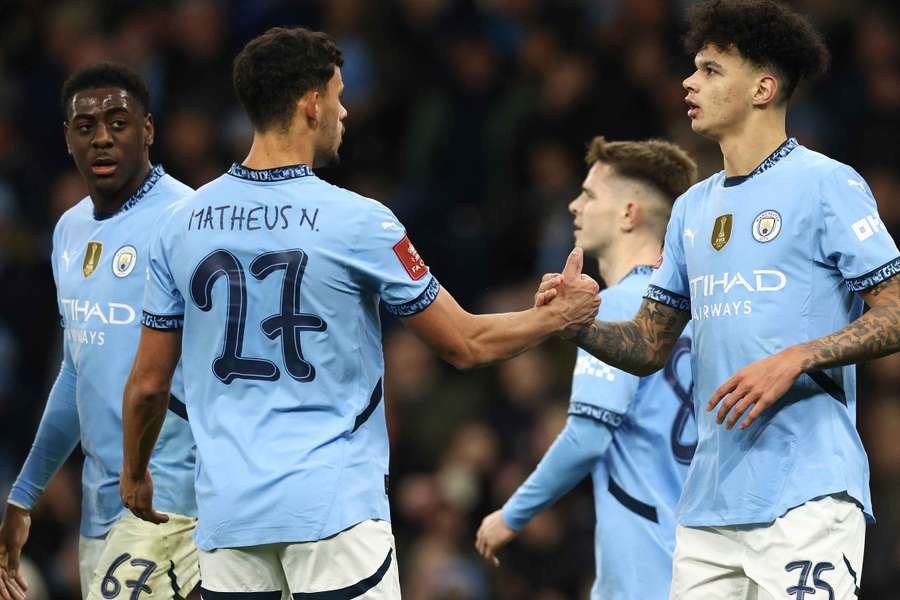 Nico O'Reilly (R) celebrates scoring the third goal with Matheus Nunes 