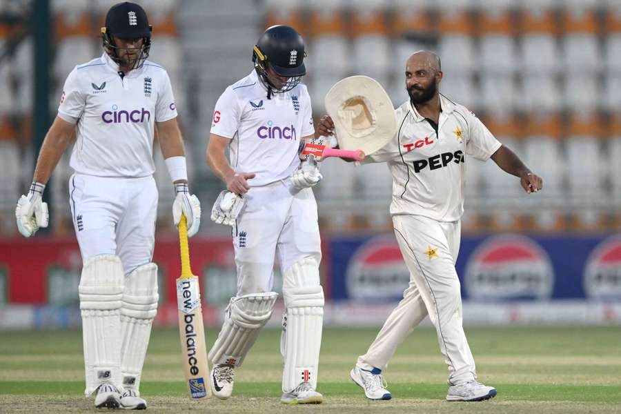 Pakistan bowler Sajid Khan shares a joke with England batsman Ollie Pope