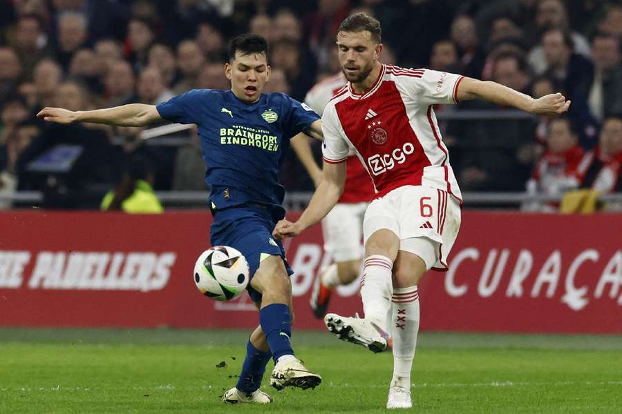 Ajax Amsterdam's Jordan Henderson in action with PSV Eindhoven's Hirving Lozano