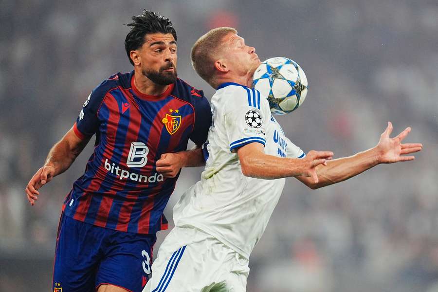FC Copenhagen's Andreas Cornelius, right, and FC Basel's Nicolas Vouilloz battle for the ball