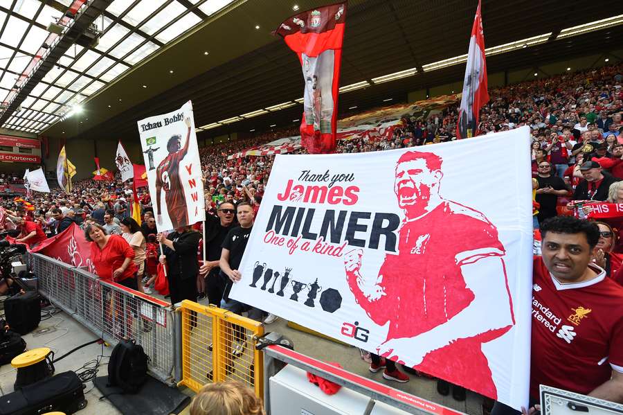 Tribute banners to Liverpool's Brazilian striker Roberto Firmino and Liverpool's English midfielder James Milner are pictured ahead of the English Premier League football match between Liverpool and Aston Villa