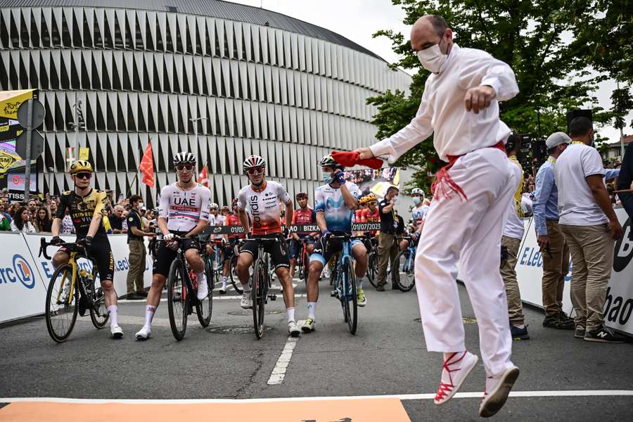 A Basque dancer at the Tour de France start, with champion Jonas Vingegaard in front of the San Mames stadium in downtown Bilbao