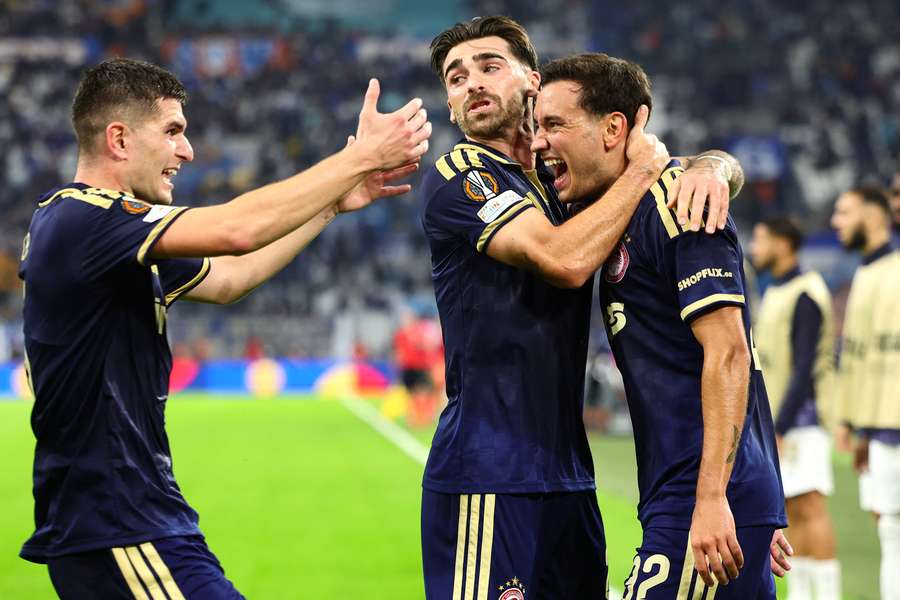 Olympiacos' Santiago Hezze (right) celebrates with teammates after scoring Olympiacos' Santiago Hezze (right) celebrates with teammates after scoring