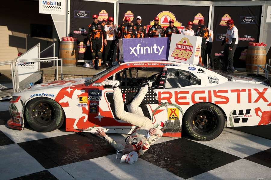 Connor Zilisch slips and falls off his car after winning the NASCAR Xfinity Series Mission 200 at The Glen at Watkins Glen International