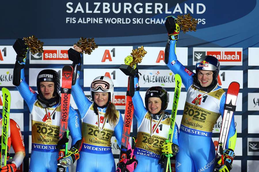 Italy's Lara Della Mea, Alex Vinatzer, Giorgia Collomb and Filippo Della Vite celebrate on the podium