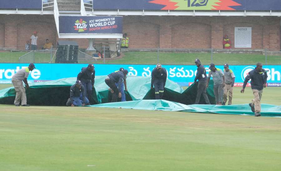 Ground staff protected the crease as rains stopped play