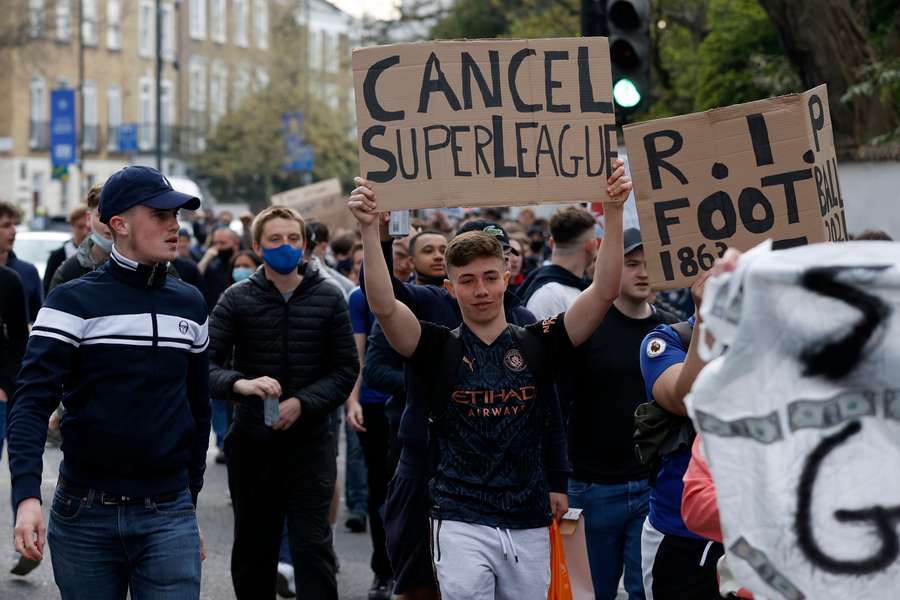 Football supporters protest against the proposed European Super League outside Stamford Bridge on April 20, 2021