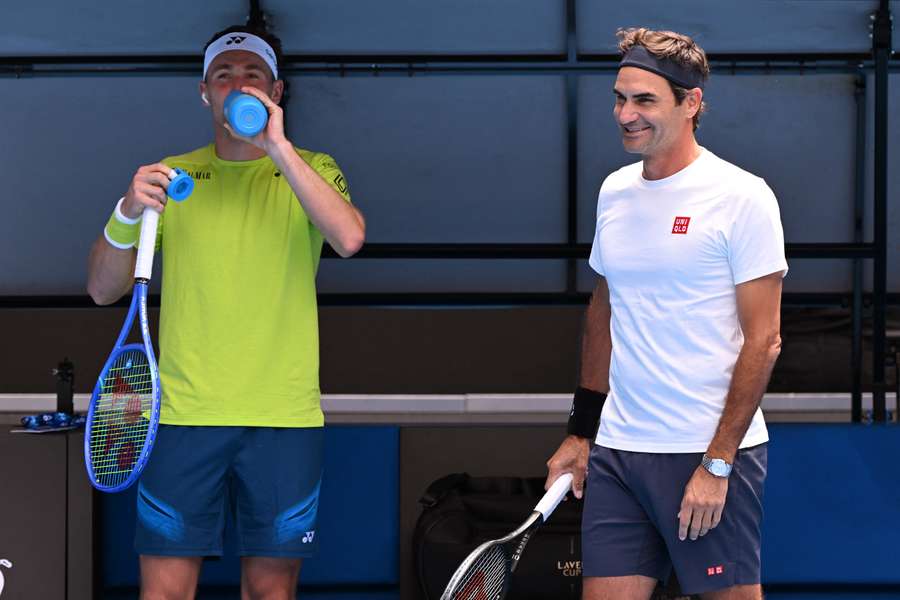Casper Ruud chats with Roger Federer during their practice match in Melbourne on Friday.