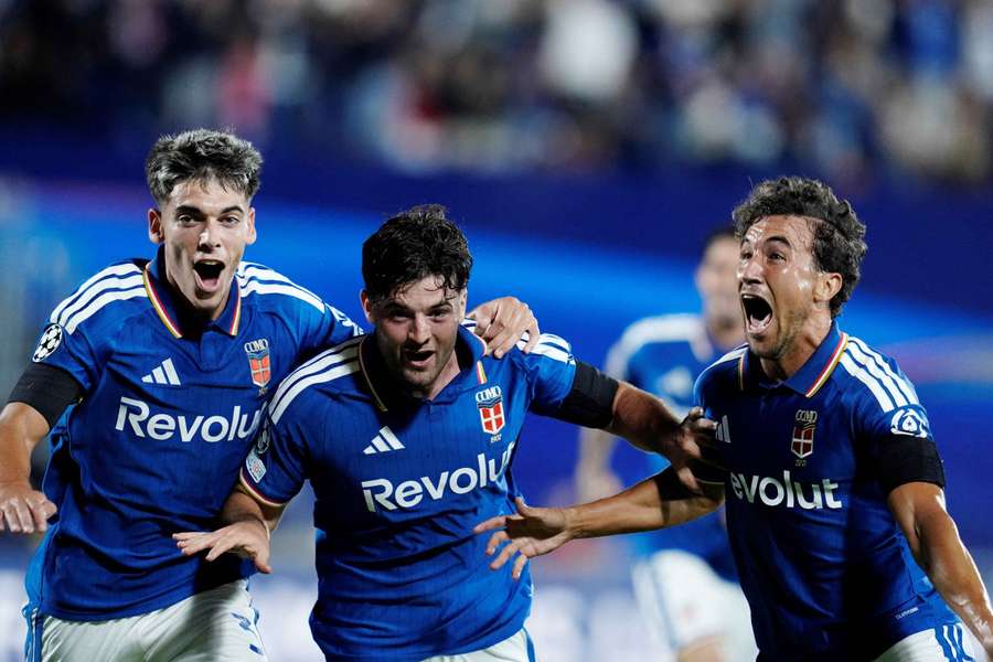 Como's Martin Baturina celebrates scoring their first goal with Alex Valle and Luis Milla
