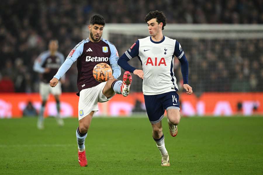 Marco Asensio of Aston Villa controls the ball under pressure from Archie Gray of Tottenham Hotspur