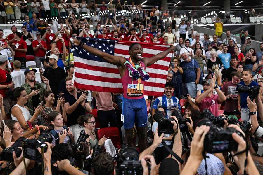 Noah Lyles celebrates surrounded by members of the media after the men's 200m final