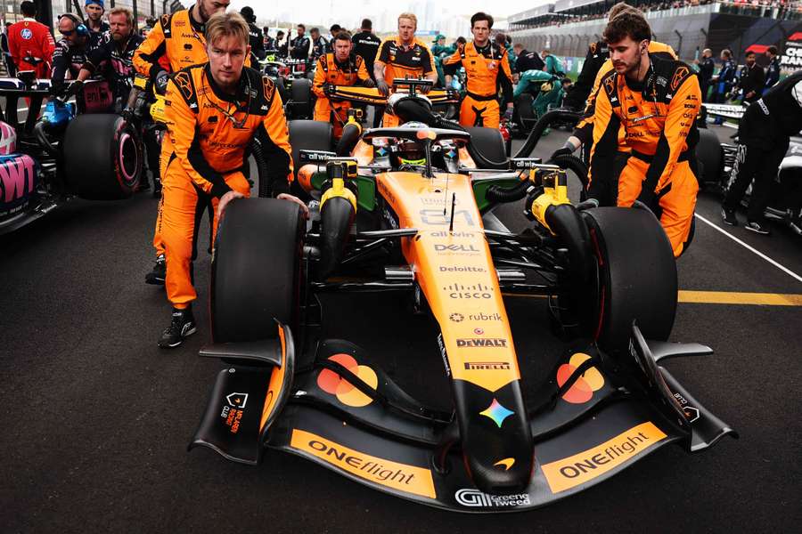McLaren mechanics bring the race car of Oscar Piastri onto the track before the race McLaren mechanics bring the race car of Oscar Piastri onto the track before the race