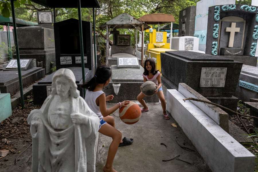 Girls practice dribbling basketballs at Manila South Cemetery in Makati