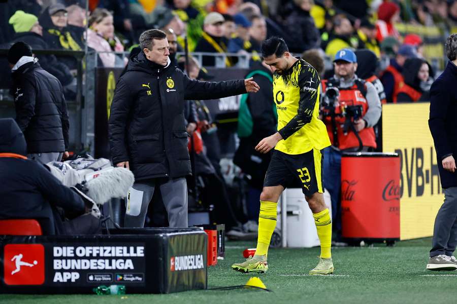 Borussia Dortmund's Emre Can is substituted off for Ramy Bensebaini after sustaining an injury 
